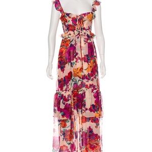 Multicolor floral sleeveless maxi dress. Ruffles at hem and tie at bust.